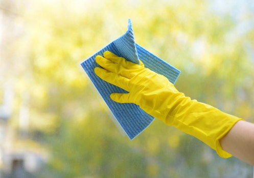 Cleaner preparing a guest-ready Airbnb living room in Queenspark