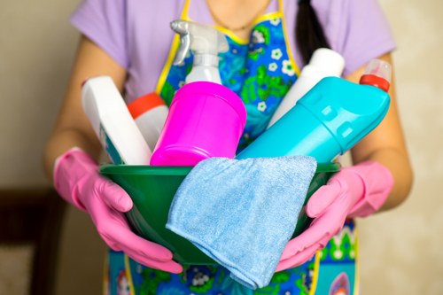 Technician managing electrical equipment and cables during carpet cleaning