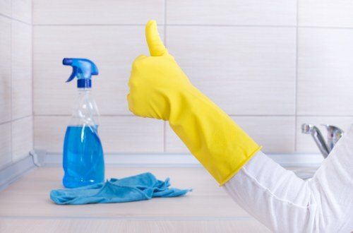Professional cleaner preparing a Queenspark property for handover